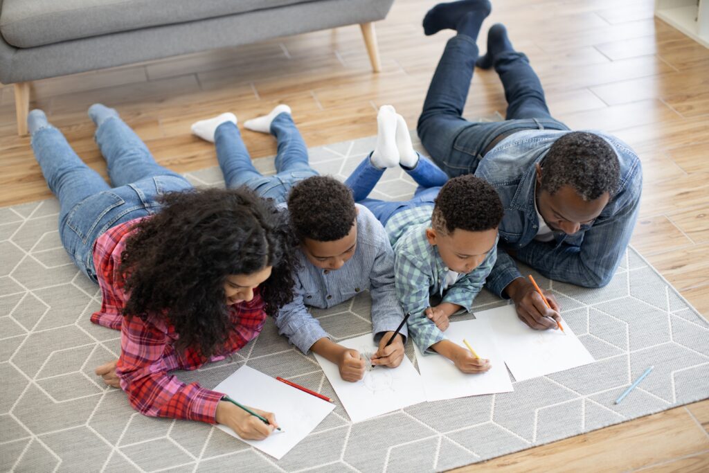 family drawing together on the living room